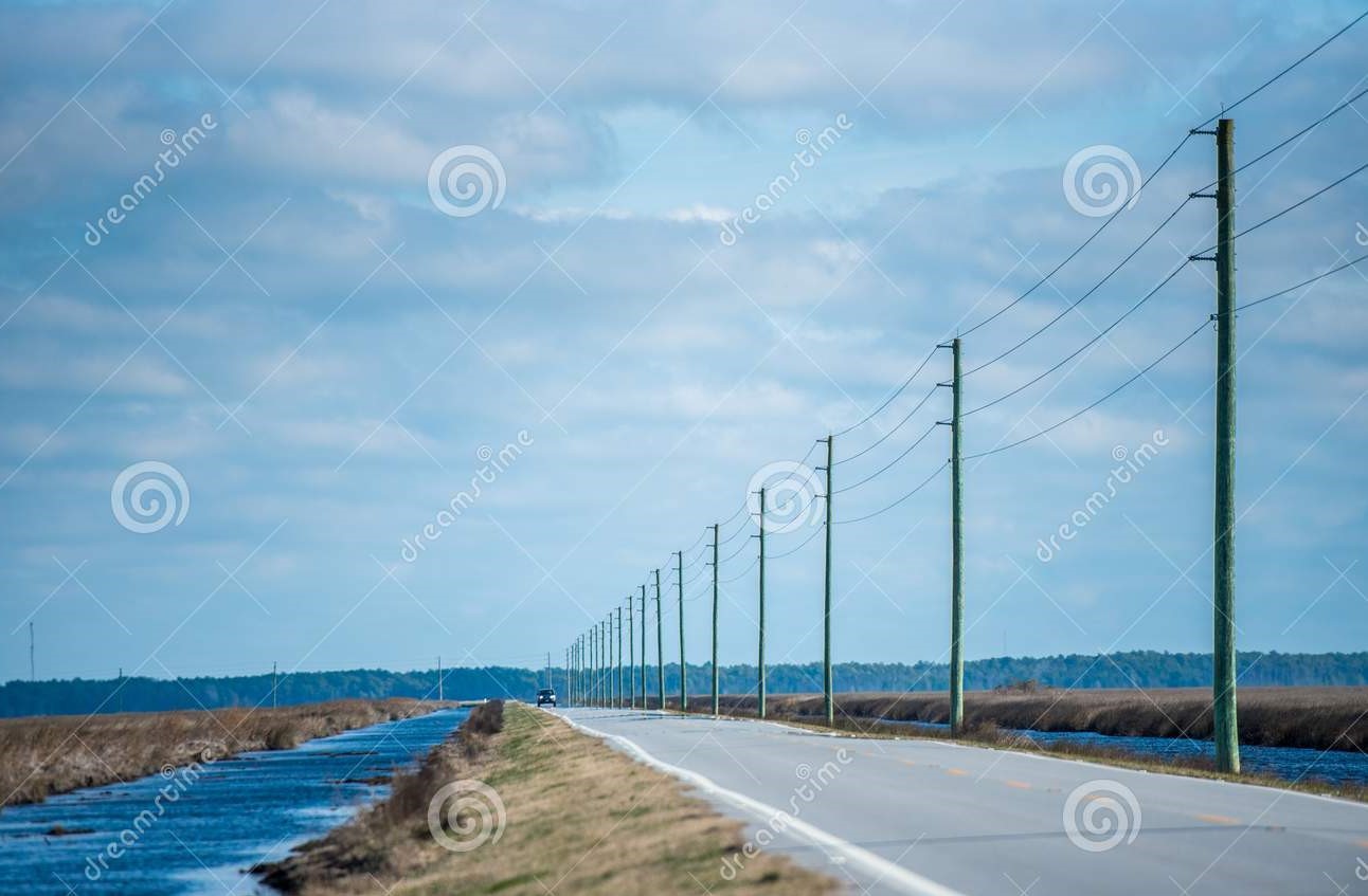 telephone-poles-following-highway-north-carolina-telephone-poles-side-highway-marshlands-north-108127124